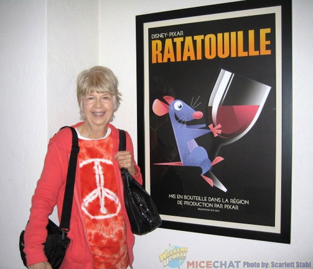 Maggie in front of the poster of Ratatouille.