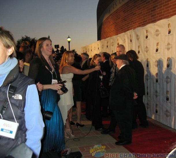 Press and crowd scene with Eric Goldberg (prominent animator of Get a Horse) at the microphone