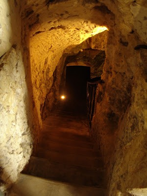 An escape tunnel leading beneath the castle and into the forest beyond