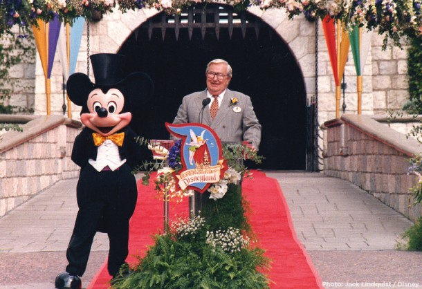 Jack Lindquist speaking at a Disneyland Ambassador event in front of Sleeping Beauty Castle
