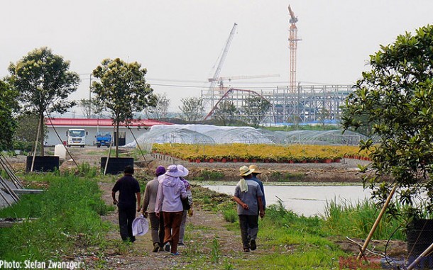 Farmers with the Tron Coaster in the distance.