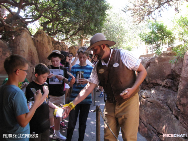 Willum works the Big Thunder line to hand out name badges, and encourage people to play after they get off the ride.