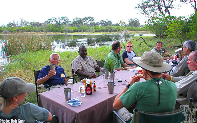 True-Life Adventure Bob enjoys a gin and tonic at a hippo filled pond