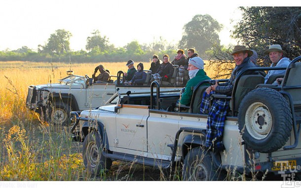 These folks are watching a leopard just a few yards distant that ignores them