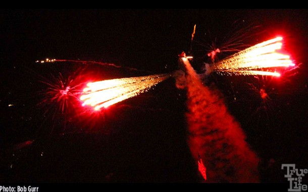 A helicopter air launches fireworks during the spectacular night airship