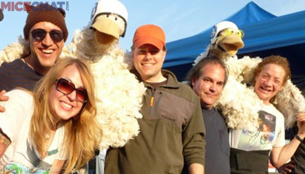Terri holding chicken over Rick, next is Drew and Frank has the beanie with the ears. The young lady helps keep the chickens looking good.