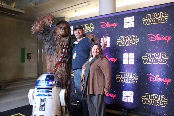 Chewie is standing on his toes to be taller than Noe.