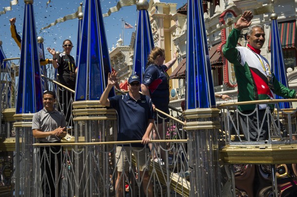 (May 6, 2016): Competitors from the Invictus Games Orlando 2016 were treated to a hero&rsquo;s welcome at Magic Kingdom today. USA Army Sergeant First Class Yancy Taylor (front center) and Jordanian Army Private Jamal Damra (front right) wave to the crowd while he and other athletes representing many of the participating countries from around the world took part in a parade down Main Street U.S.A. amid a sea of confetti. (Disney)