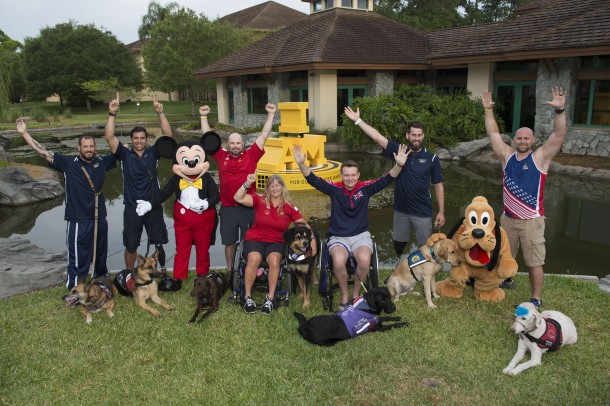 (May 12, 2016): Ahead of the Invictus Games Orlando 2016 closing ceremony, Mickey Mouse and Pluto celebrate service dogs and competitors, (L-R) Leonard Anderson with Azza, August O&rsquo;Niell with Kai (USA), Luc Martin with Trail, Christine Gauthier with Battak (Canada), Jon Flint with Jester (Great Britain), Stefan LeRoy with Knoxville and Brett Parks with Freedom (USA), Thursday, May 12, 2016, at Walt Disney World Resort in Lake Buena Vista, Fla. Founded by Prince Harry, Invictus Games is the only adaptive sporting event for injured active duty and veteran service members. (David Roark, photographer)