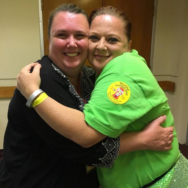 Michele King (on the left) gives out one of her famous hugs during the Rally.