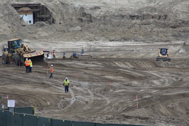 Construction crews lay out markers. 