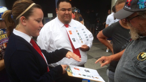 Outside, Cast Members had pictures of the exclusive merchandise to show the crowd.