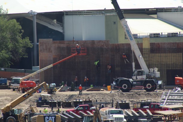 Workers are building the rebar skeleton of a wall. 