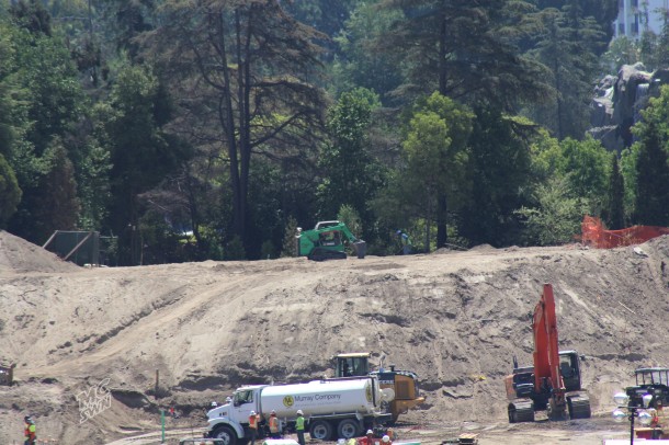 Where the Skyway Chalet stood, workers are planting new bushes on the side facing Fantasyland.