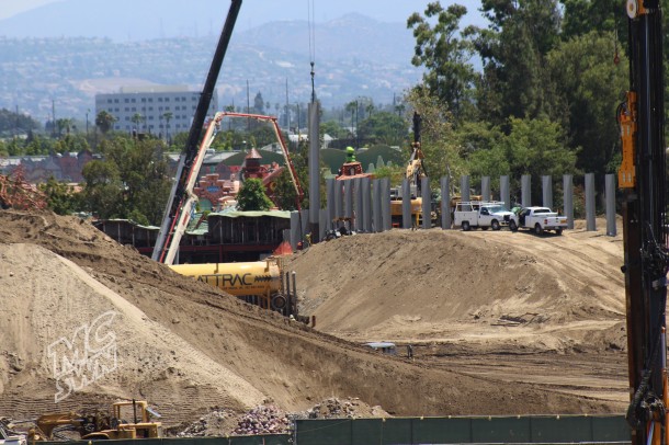 More beams are being put in the ground behind the Fantasyland Theater. Possibly for a retaining wall next to the new train tracks. 