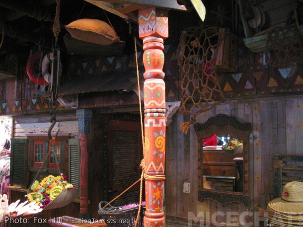 The exotic look of the Adventureland Bazaar was designed and built by Rolly. He used some materials rescued from the "bone yard" storage area of disused items. These turned posts were originally part of teh Chicken Plantation Restaurant. Rolly put them here himself, and never miss an opportunity to "commune" with them. They were touched by greatness.