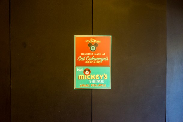 Signage telling you where to go for Photopass and merchandise.