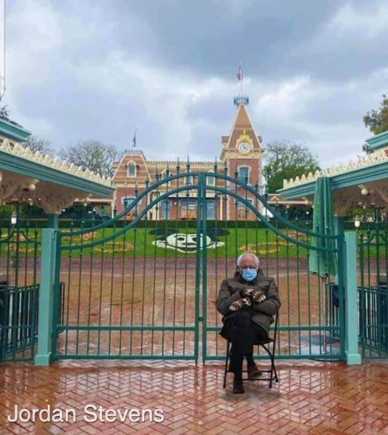 Bernie Sanders sits at the Disneyland front gate.