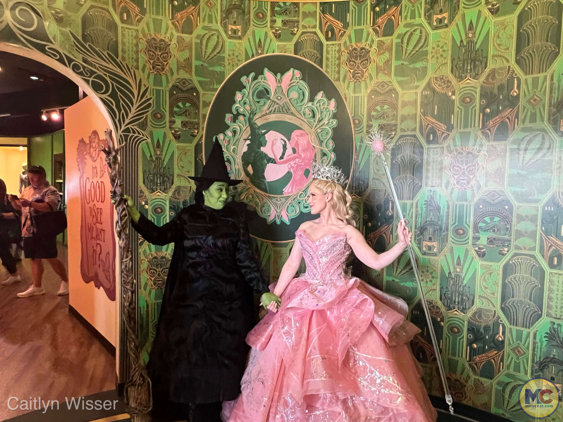 Elphaba and Glinda smiling at each other at their meet and greet at the Wicked store at Universal Orlando Resort
