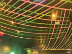Green and pink streamers on the ceiling of the interior of the Wicked store at Universal Orlando Resort