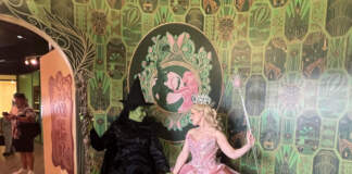 Elphaba and Glinda smiling at each other at their meet and greet at the Wicked store at Universal Orlando Resort