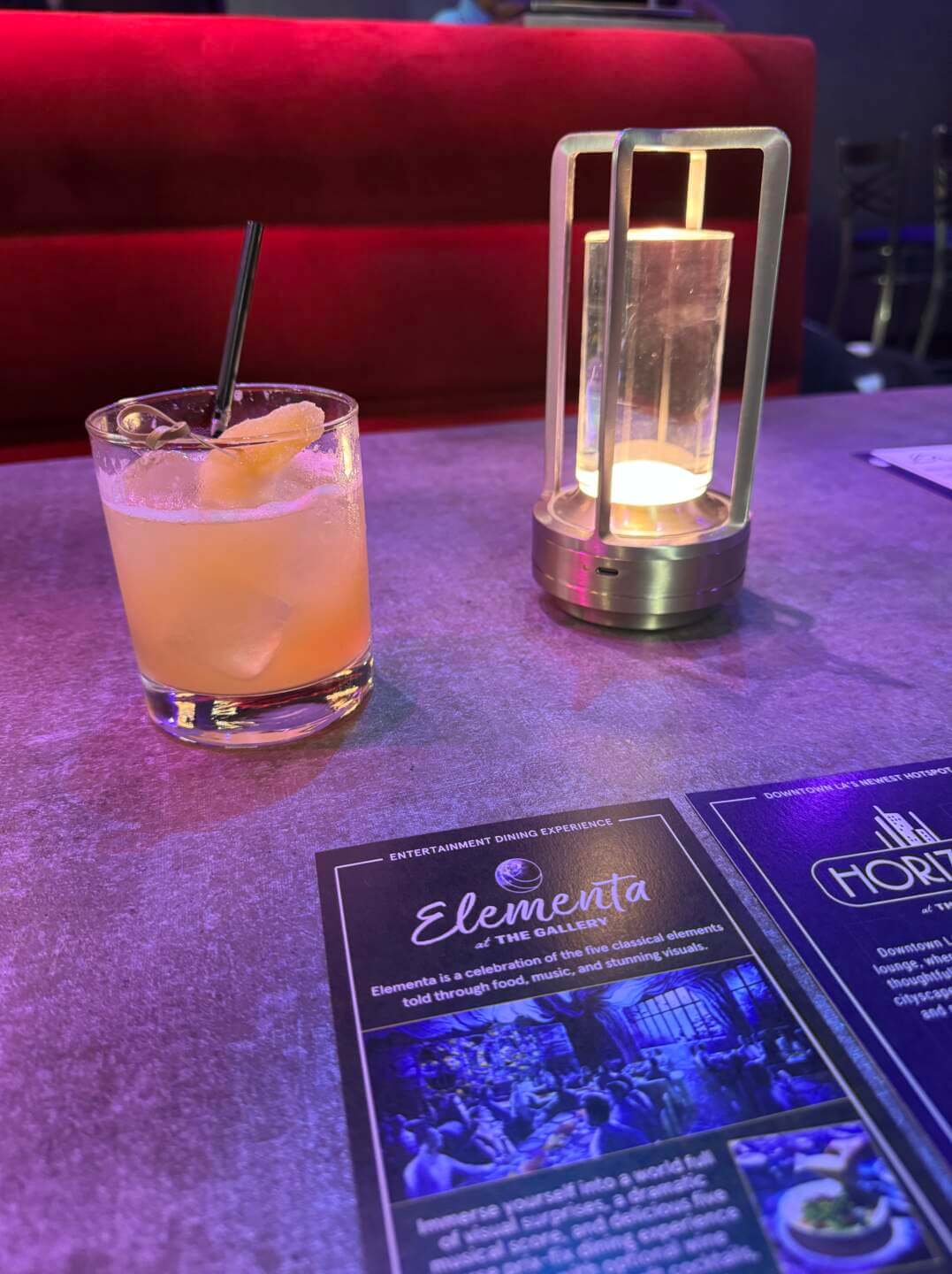 A yellow alcoholic drink sitting on a table