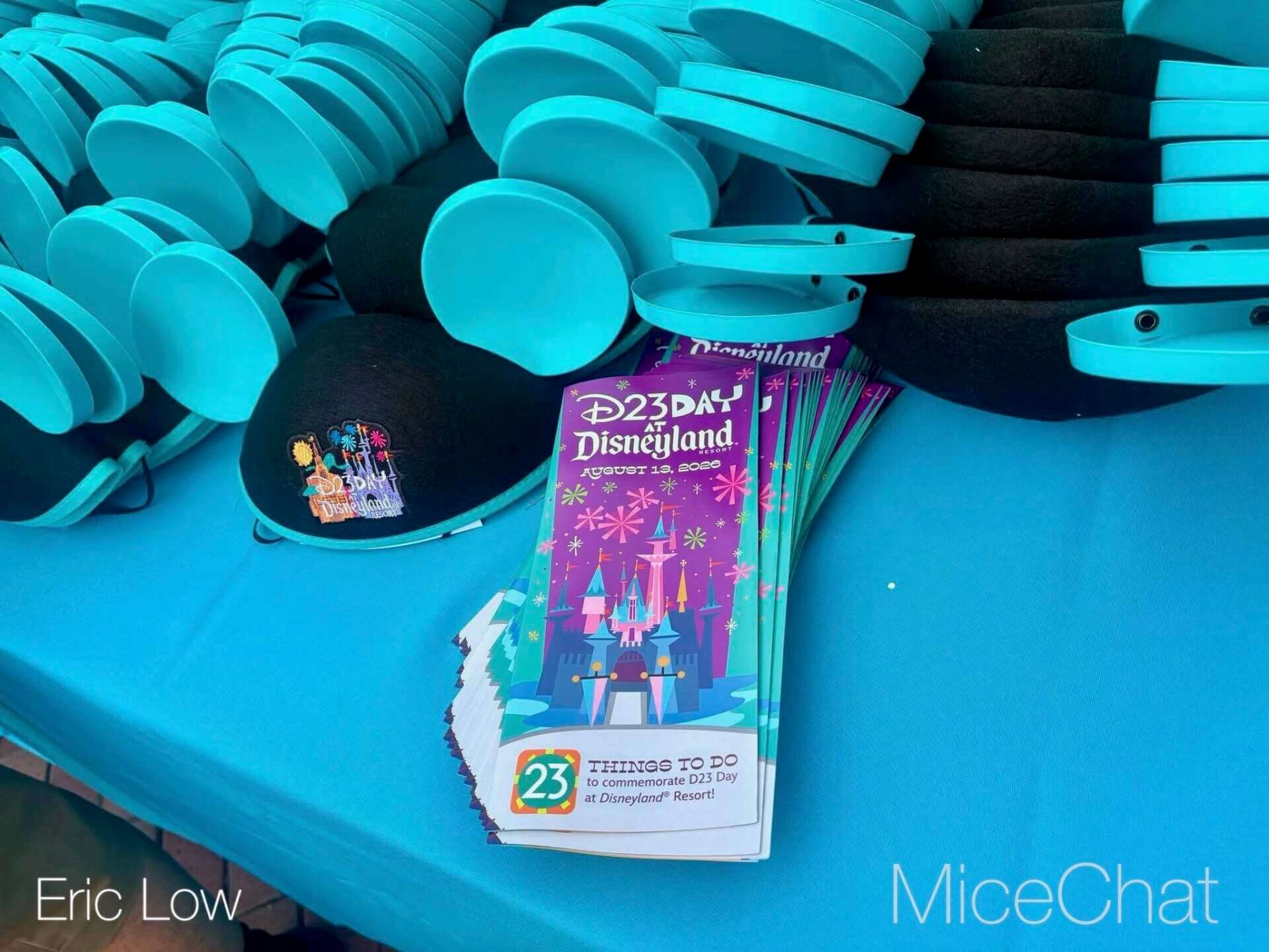Guest wearing the free turquoise D23 Day Mickey ear hat at Disneyland