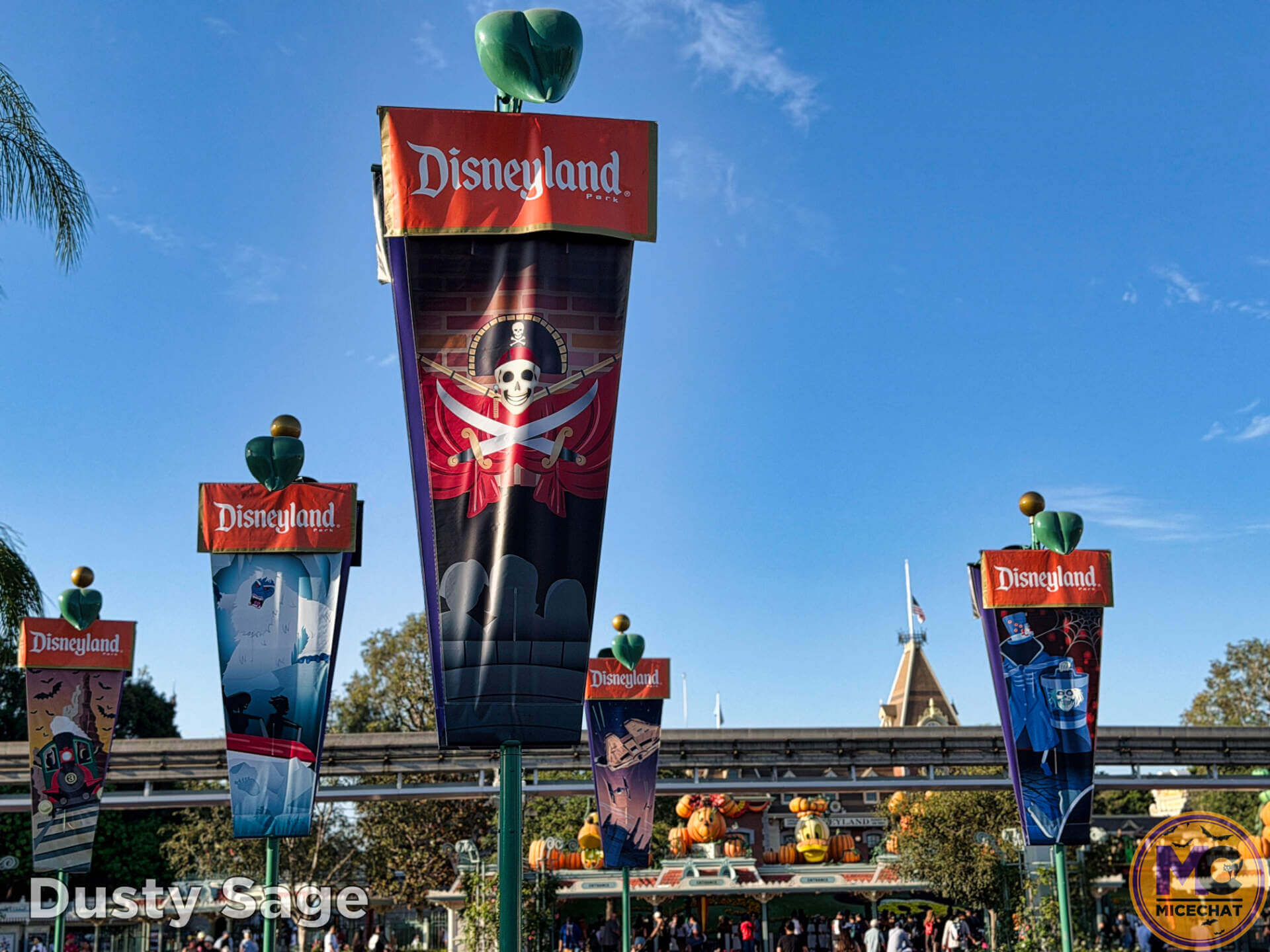 Halloween character flags flying over the Disneyland Resort esplanade