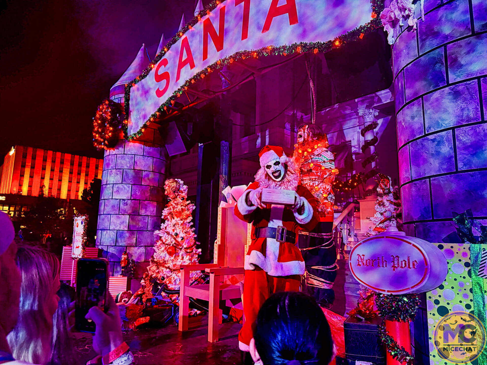 Art the Clown dressed as Santa in Downtown Clowntown at HHN 2026
