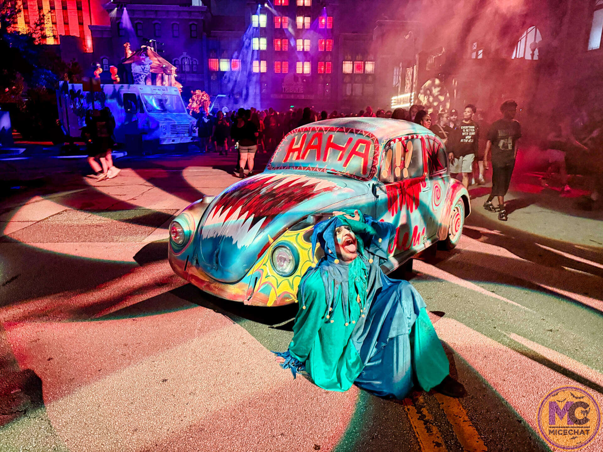 A Killer Klown beside the HAHA car in Downtown Clowntown at HHN 2026