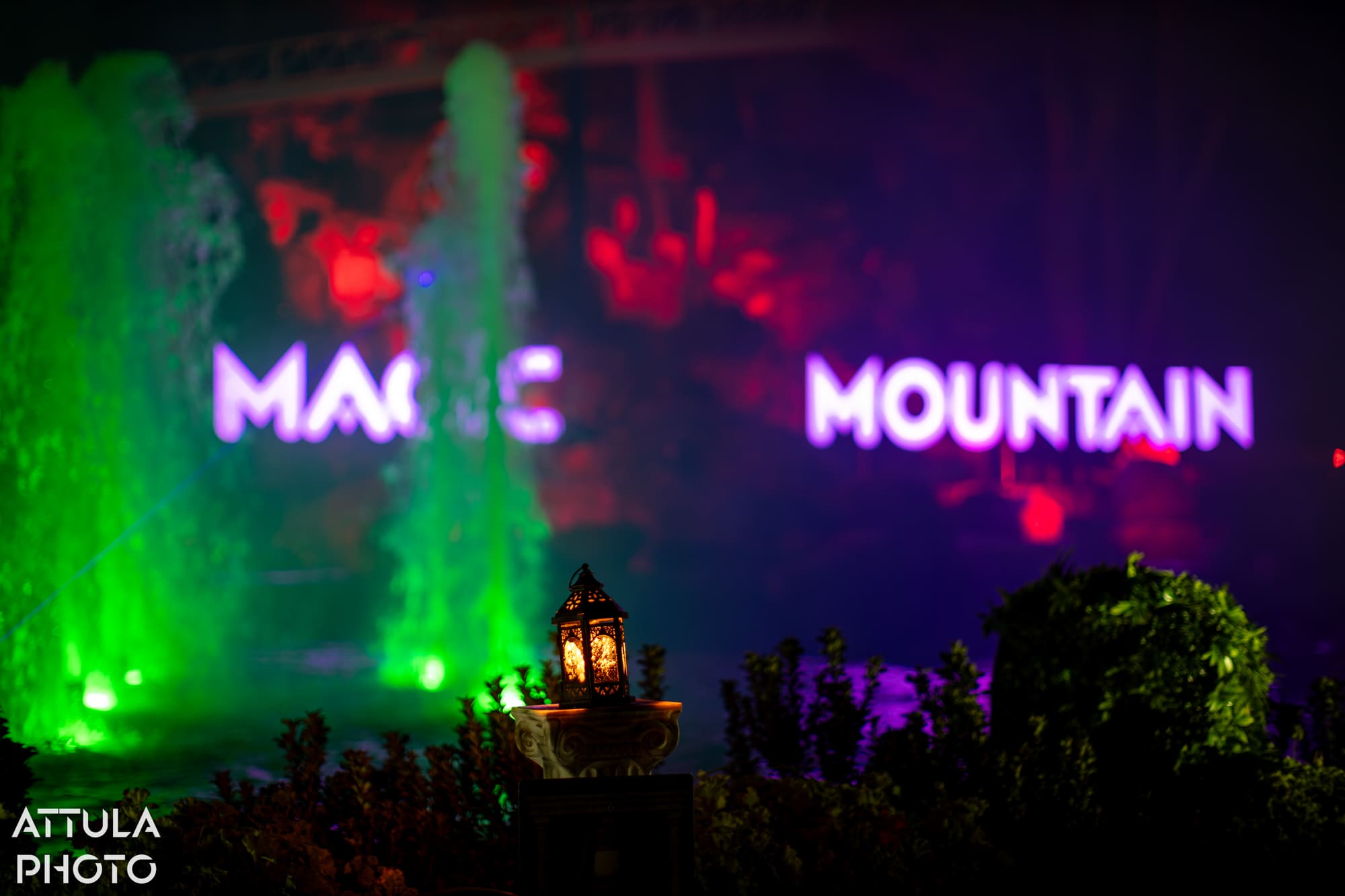 Central fountains lit up during a lantern activation at Six Flags Magic Mountain