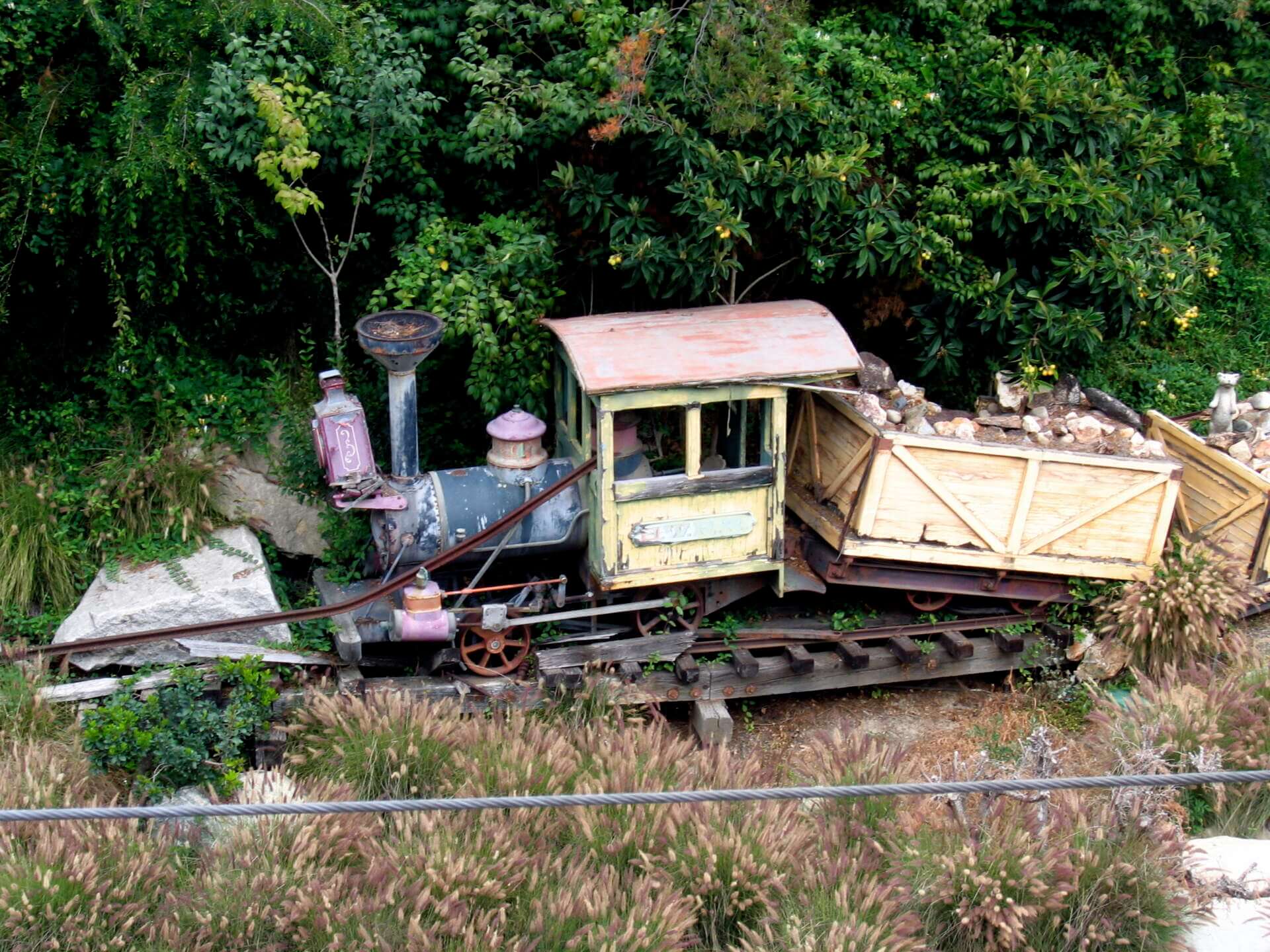 The retired Nature's Wonderland mine train locomotive and cars sitting abandoned at Disneyland