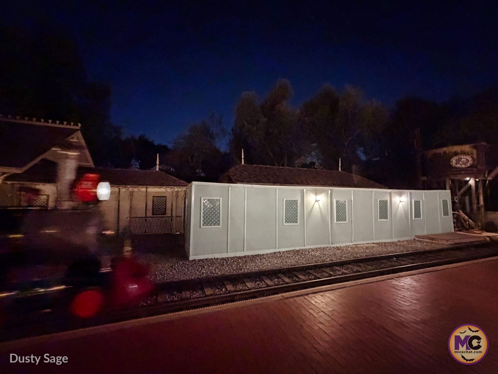 Construction walls along the Disneyland Railroad tracks at night