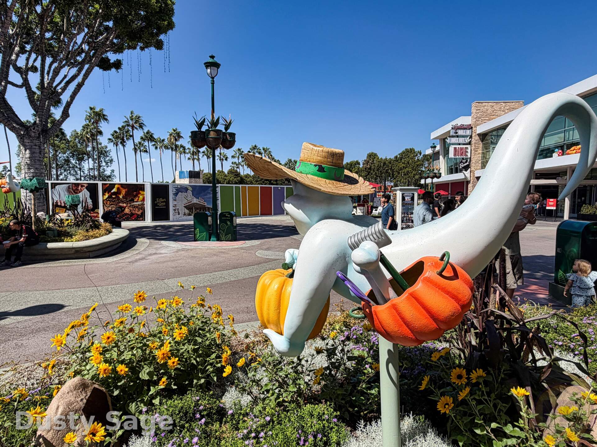 Construction walls for Arthur and Sons and Pearl's Roadside BBQ in Downtown Disney, framed past a Zero Halloween figure