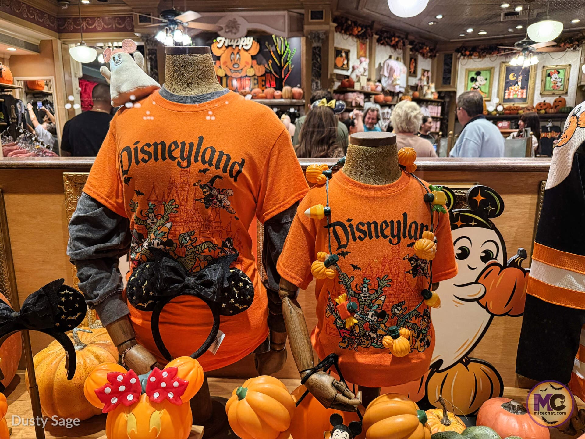 Orange Disneyland Halloween shirts on display in a Main Street shop