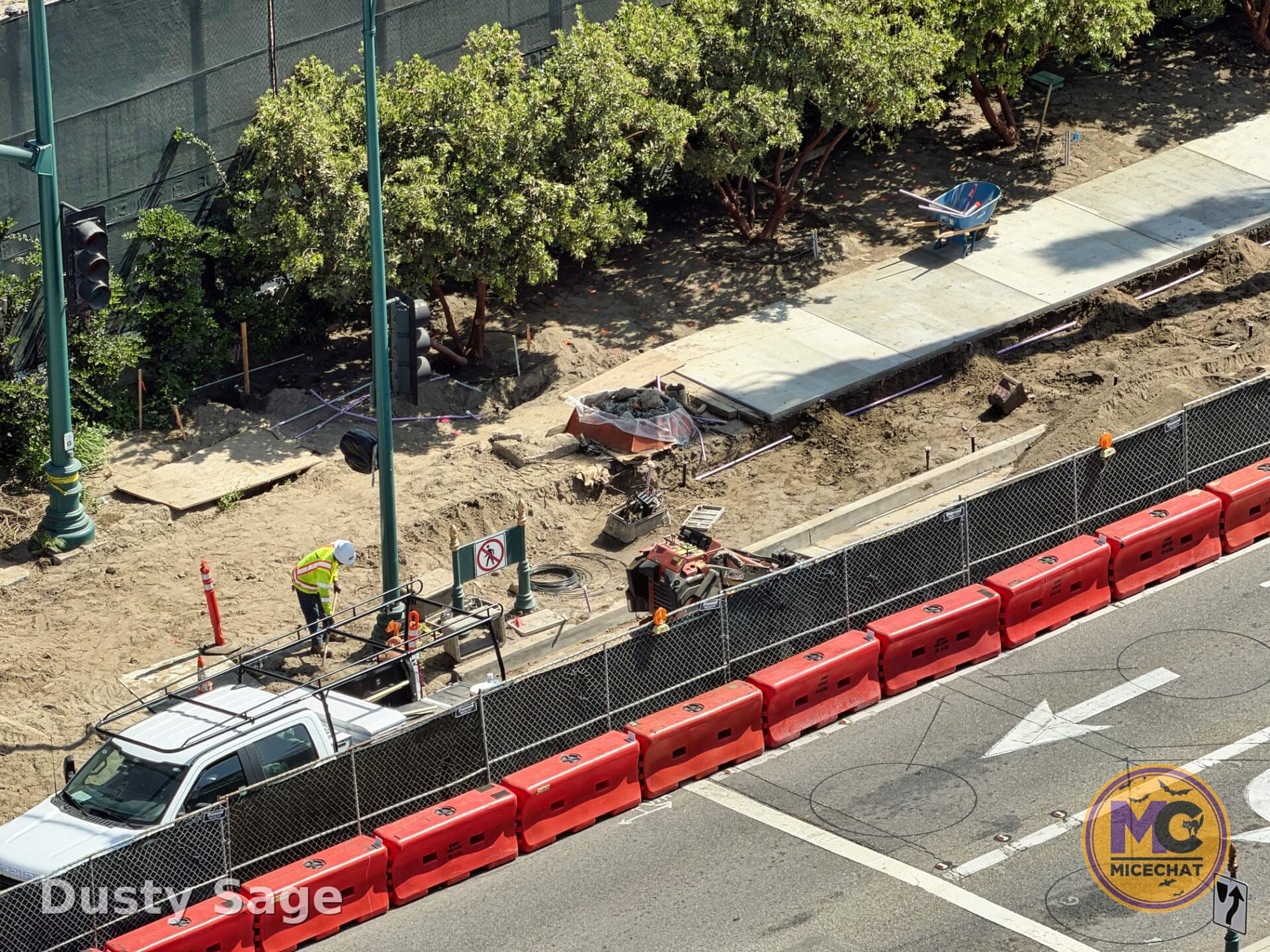 Ground-level detail of barriers and dirt work at the Coco boat ride construction site